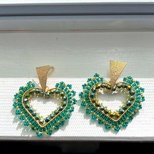 Heart shaped emerald green beaded earrings.